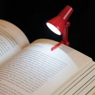 Adjustable Small Reading LED Clip Desk Lamp Light Night Book Reader Travel Mini2 in 1 Adjustable LED Light With Book Clip The 2 in 1 adjustable light is a fantastic modern product that can clip onto books or onto laptops. Book clip included. Supplied in 4 colours Blue or Red or Green or Purple - we will send a random colour. Requires 3 AG3 batteries (included). ON / OFF switch. A battery powered LED mini Desktop Book Lamp. Clip onto your book or stand alone by your laptop