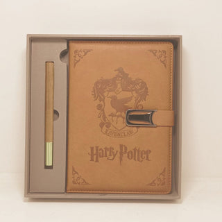 Brown leather notebook with 'Harry Potter' and Ravenclaw crest in a box on a light beige background