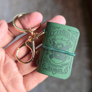 Green Slytherin Hogwarts Diary keychain held in a hand