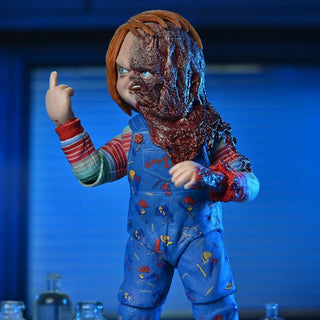 Action figure of a character in blue overalls with a red and white striped shirt, pointing forward against a blue background.