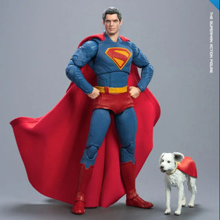 Superman action figure with a dog wearing a red cape on a gray background