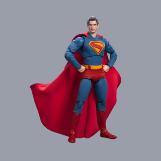 Superman action figure with red cape and blue suit on gray background